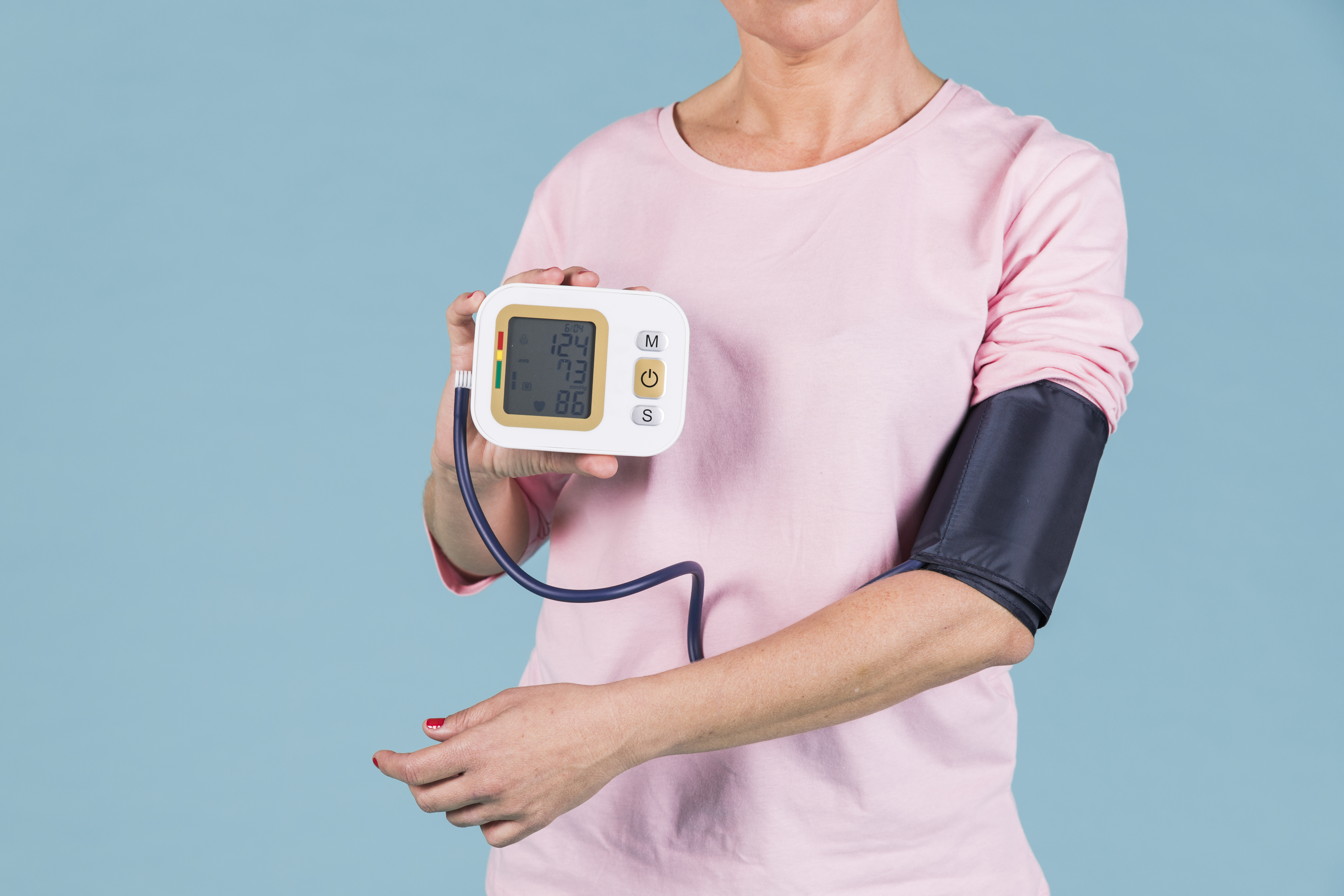 woman-showing-results-blood-pressure-electric-tonometer-screen
